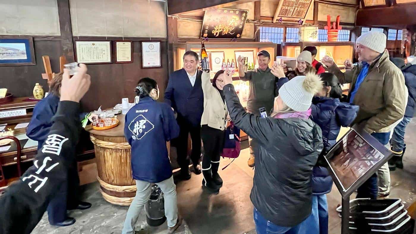 Kimi no I sake brewery group of tourists enjoying sampling the sake.