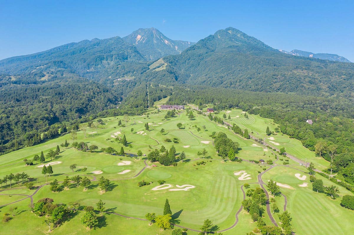A drone shot of a Myoko golf course with Mt Myoko in the background.