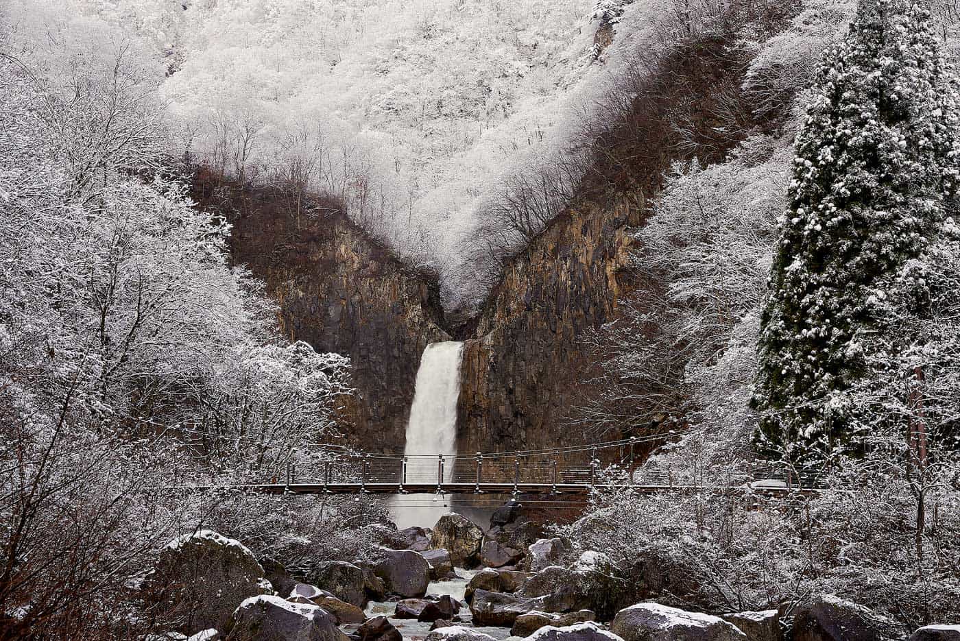Naena waterfall covered in a light snowfall.