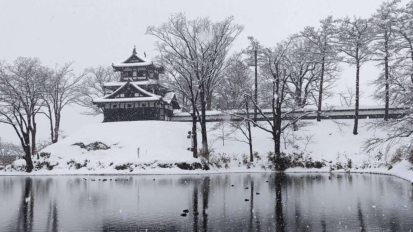 Takada Castle in Joetsu City, covered by light snow on a cold looking winters day.